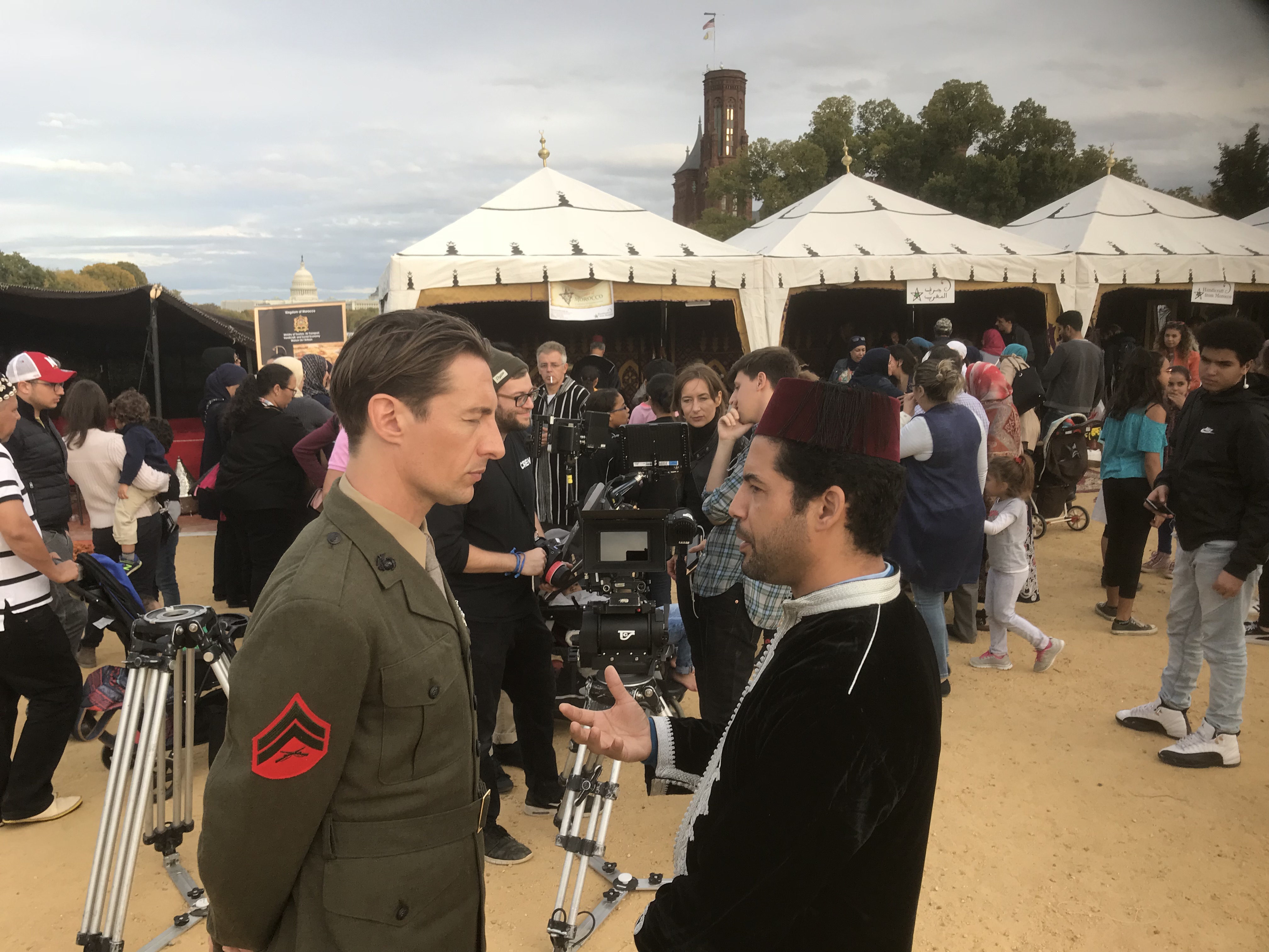 adults standing with camera man