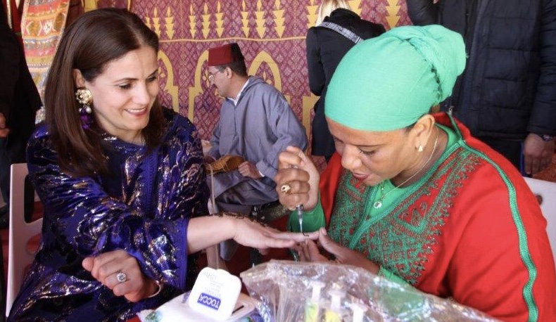 adult woman with tattoo artist